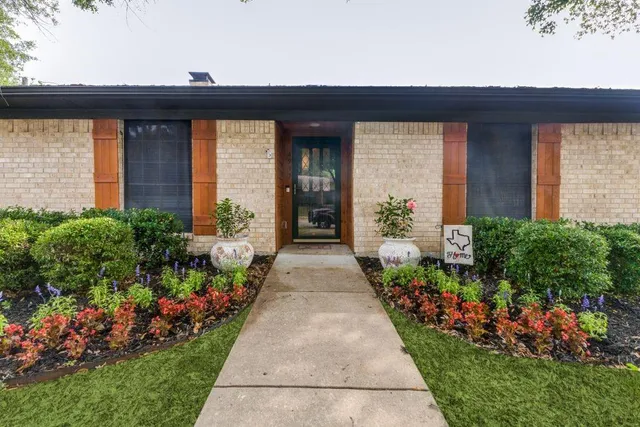 a view of a pathway with flower pots