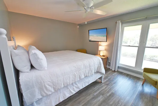 a bedroom with a bed and a large window