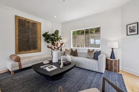 a open kitchen with stainless steel appliances granite countertop a table and chairs in it