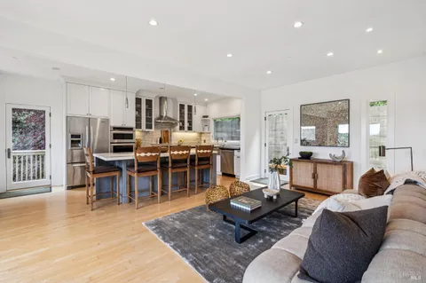 a kitchen with stainless steel appliances granite countertop a stove top oven a sink refrigerator and cabinets