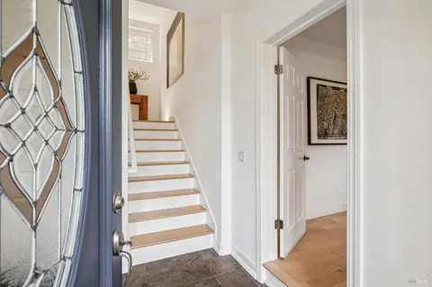 a view of a hallway with wooden floor and entryway