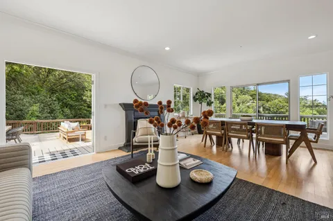 a dining room with furniture window and wooden floor