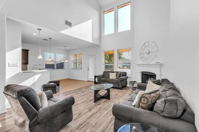 a view of kitchen with granite countertop cabinets and refrigerator
