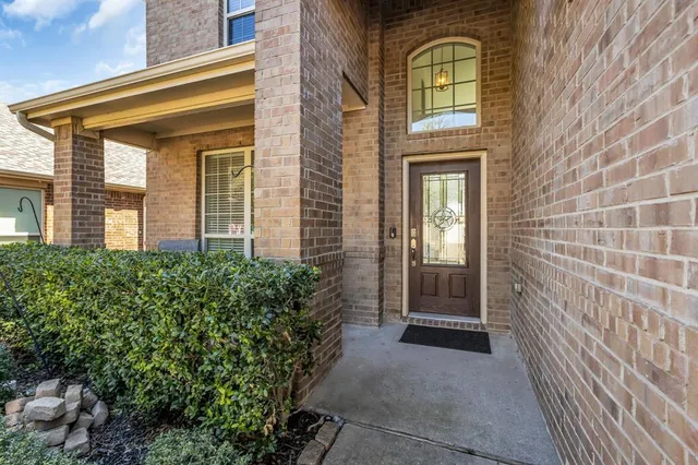 a view of a brick house with a large windows