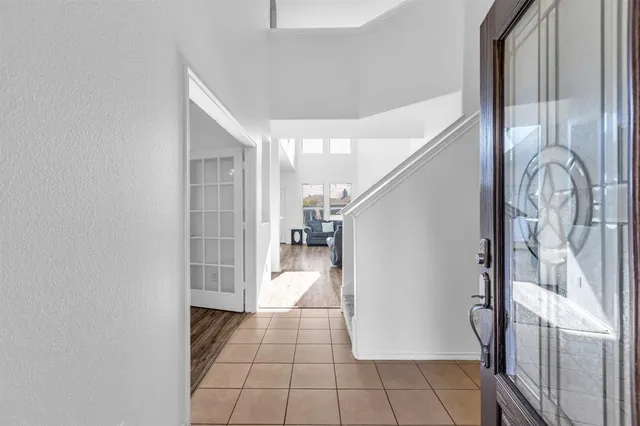 a view of a hallway with entryway wooden floor and front door