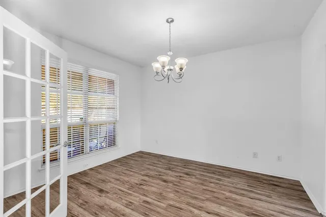 a view of a livingroom with wooden floor and stairs