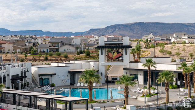 961 West Akoya Pearl Road, Unit 201 St. George, UT 84790 - Photo 45 of 67 Back of house featuring a residential view, a mountain view, a community pool, and stucco siding