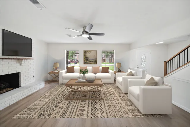 a living room with fireplace furniture and a flat screen tv