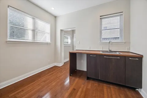 a view of a big room with wooden floor and cabinet