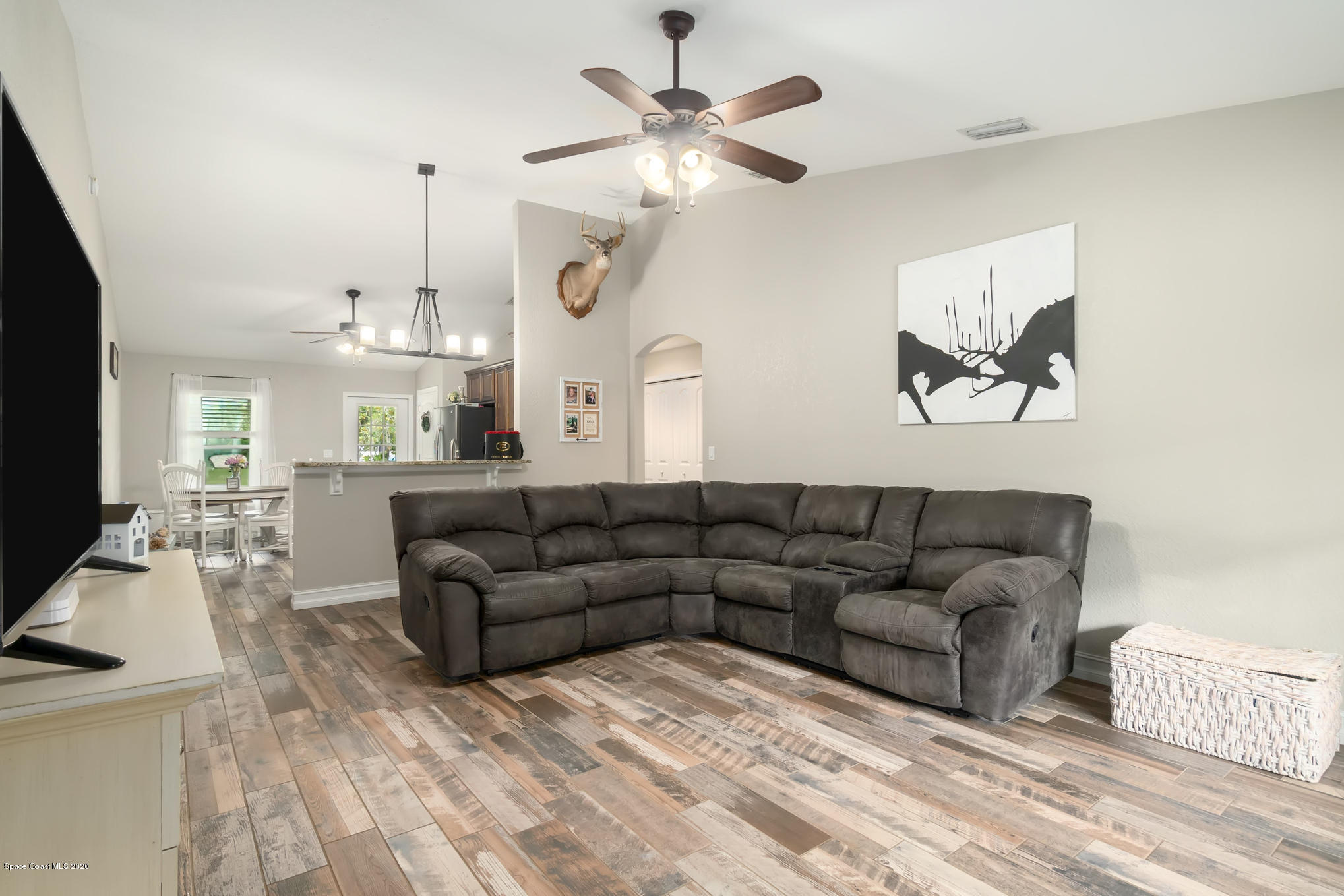 3452 Brevard Road Mims, FL 32754 - Photo 3 of 23 a living room with furniture a bed and a flat screen tv