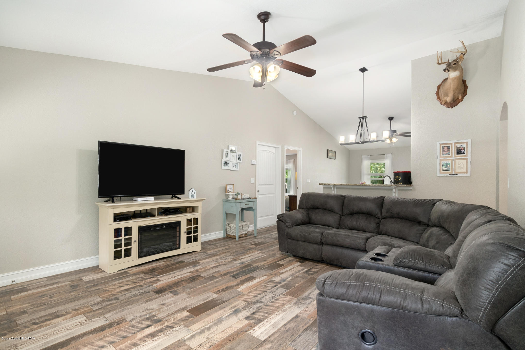 3452 Brevard Road Mims, FL 32754 - Photo 4 of 23 a living room with furniture and a flat screen tv