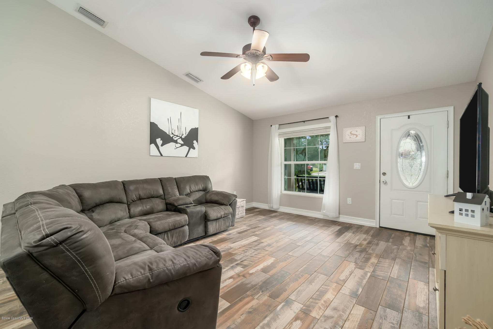 3452 Brevard Road Mims, FL 32754 - Photo 5 of 23 a living room with furniture and a flat screen tv