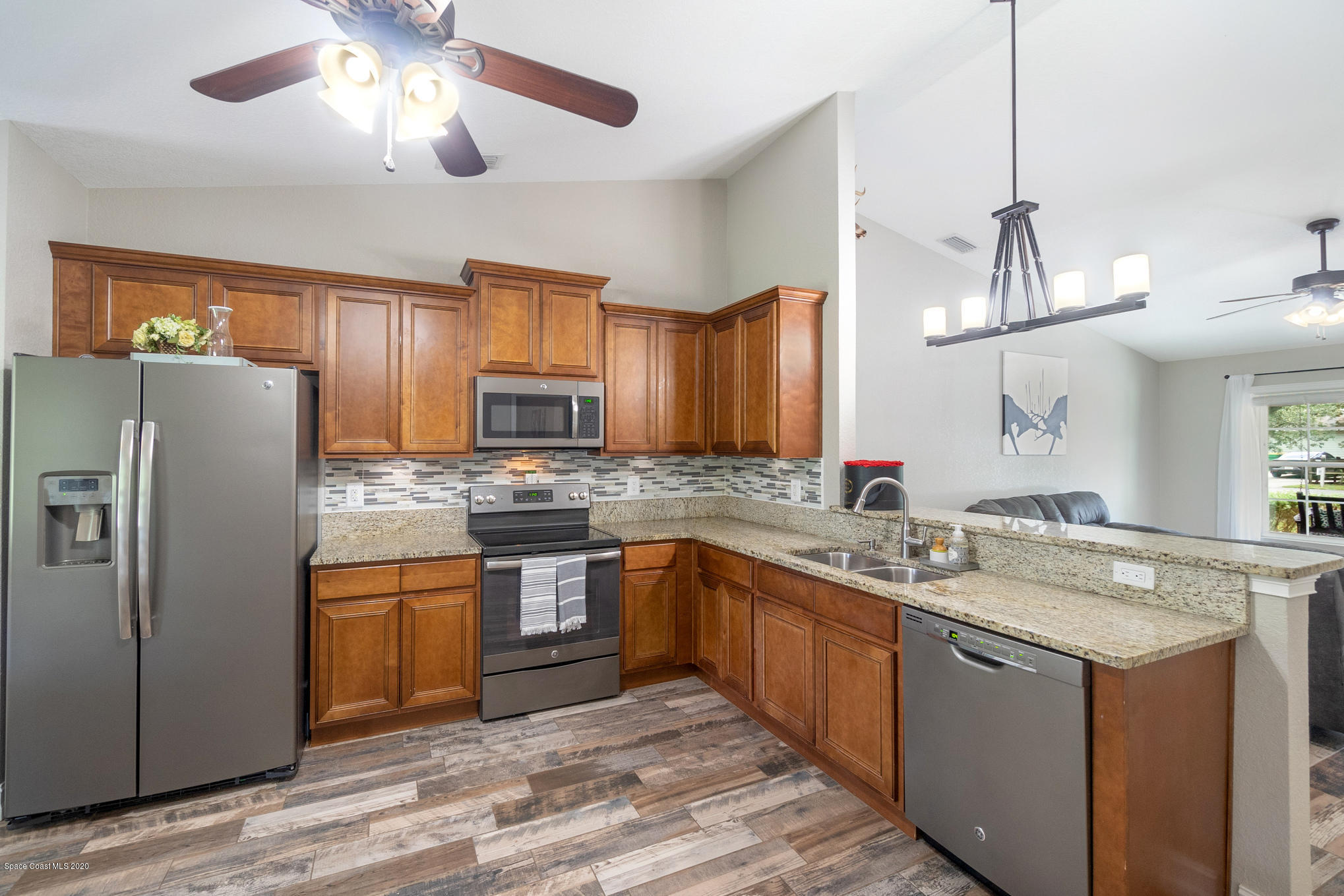 3452 Brevard Road Mims, FL 32754 - Photo 6 of 23 a kitchen with stainless steel appliances granite countertop a sink stove and refrigerator