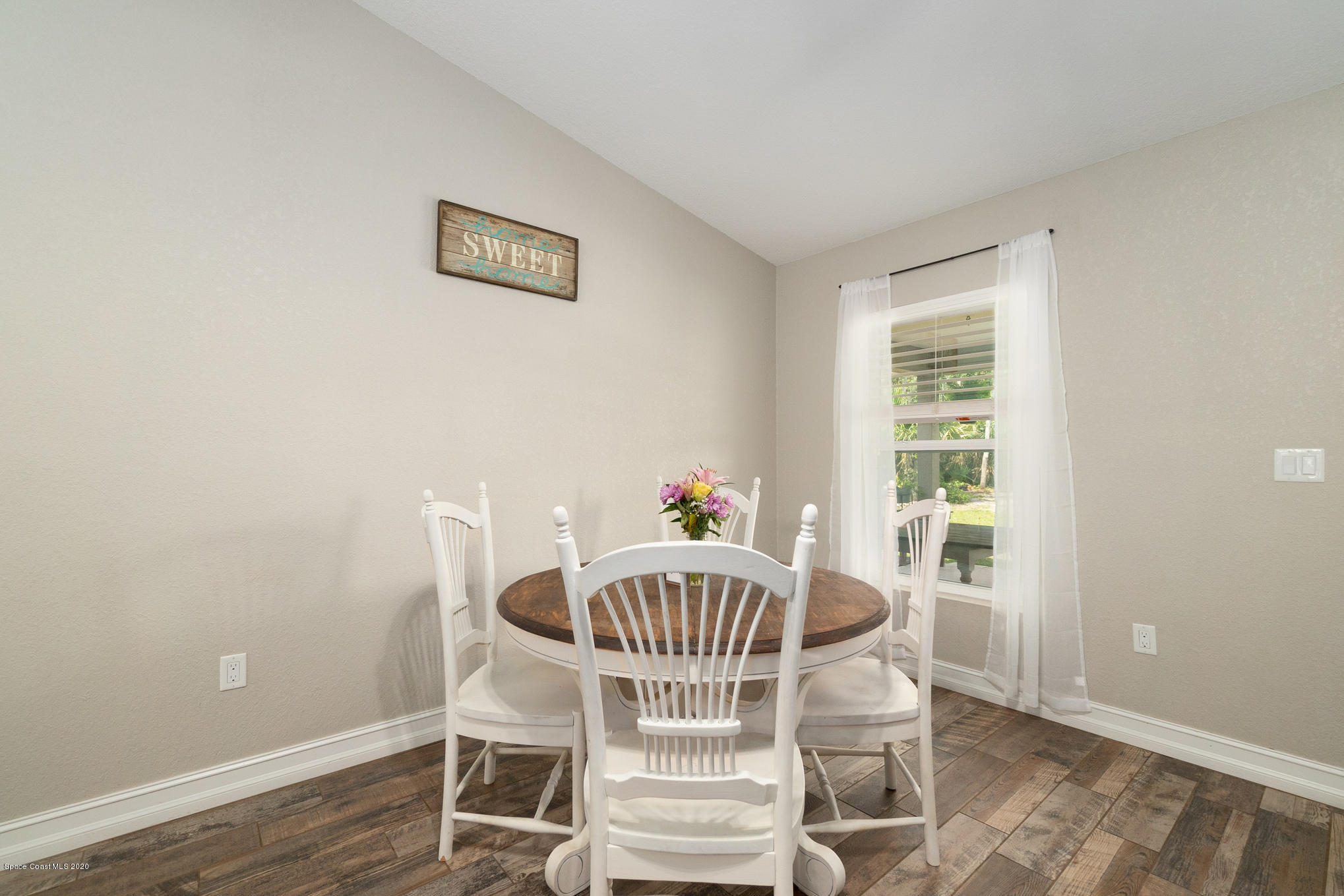3452 Brevard Road Mims, FL 32754 - Photo 9 of 23 a view of a dining room with furniture window and wooden floor