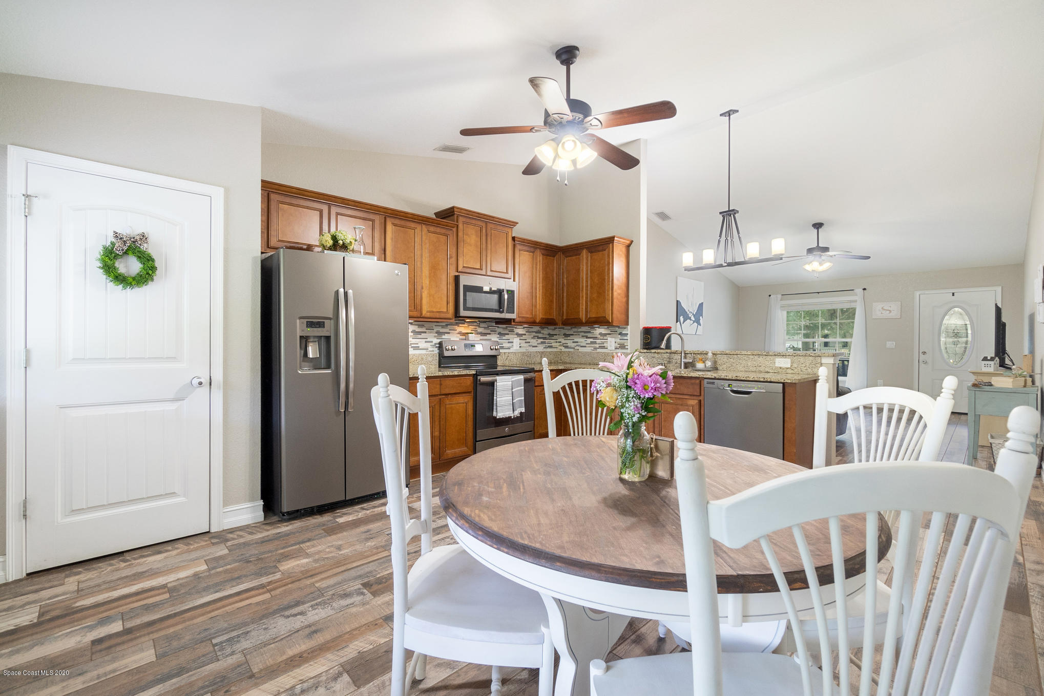 3452 Brevard Road Mims, FL 32754 - Photo 10 of 23 a view of a dining room with furniture a kitchen and chandelier