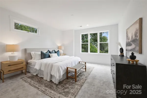 a bedroom with bed and a large window