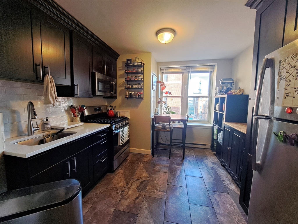 a kitchen with a sink appliances and cabinets