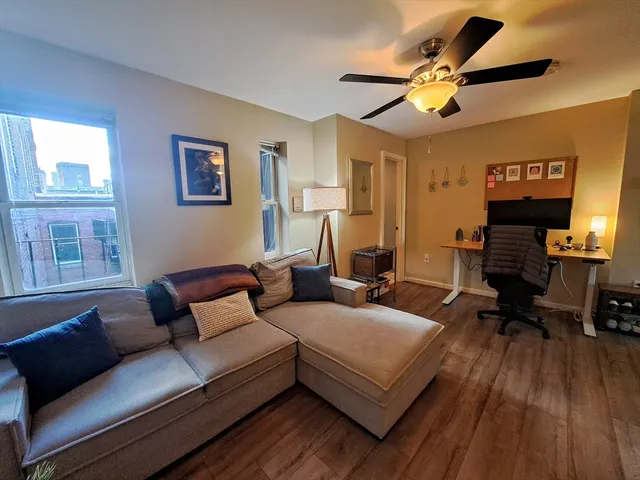 a living room with furniture and a wooden floor