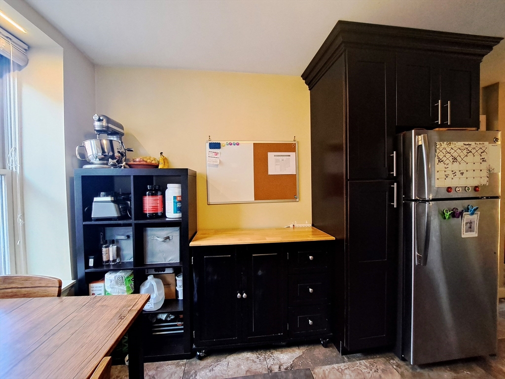 38 Charter Street, Unit 11 Boston, MA 02113 - Photo 5 of 17 a living room with refrigerator and table