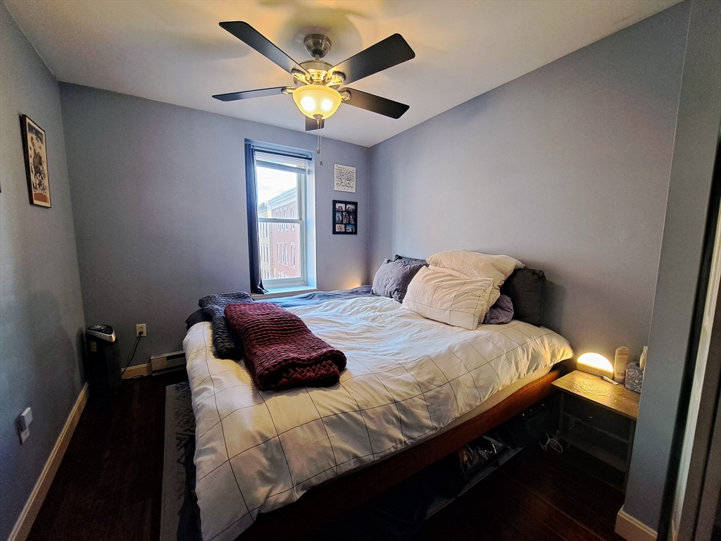 38 Charter Street, Unit 11 Boston, MA 02113 - Photo 9 of 17 a bedroom with a bed and a chandelier