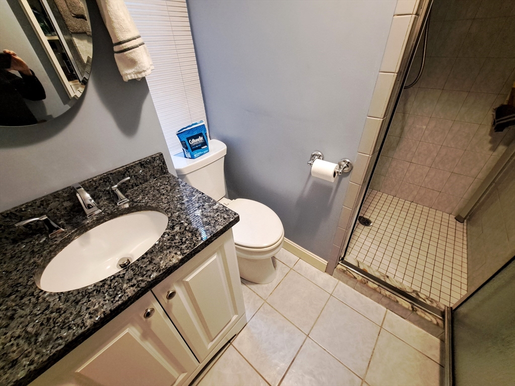 38 Charter Street, Unit 11 Boston, MA 02113 - Photo 10 of 17 a bathroom with a granite countertop sink and a mirror