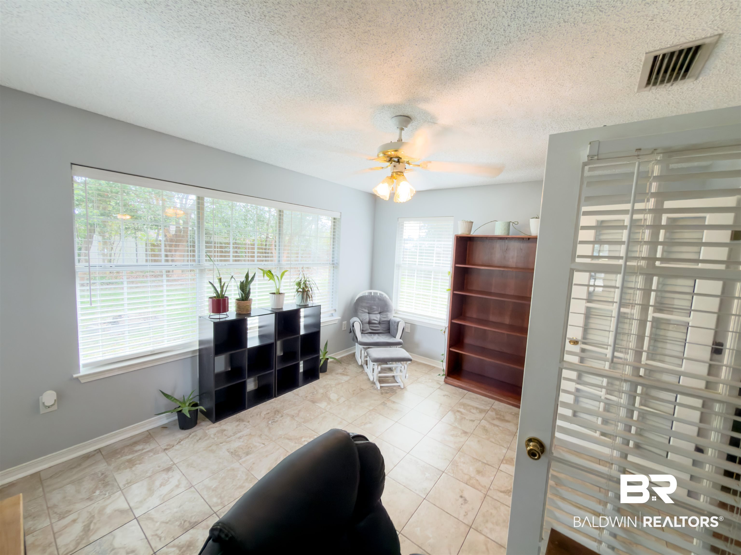 129 Pennbrooke Loop Foley, AL 36535 - Photo 10 of 44 Living area with a textured ceiling and a ceiling fan