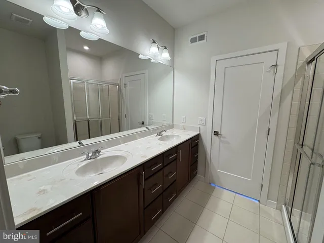 a bathroom with a glass shower door