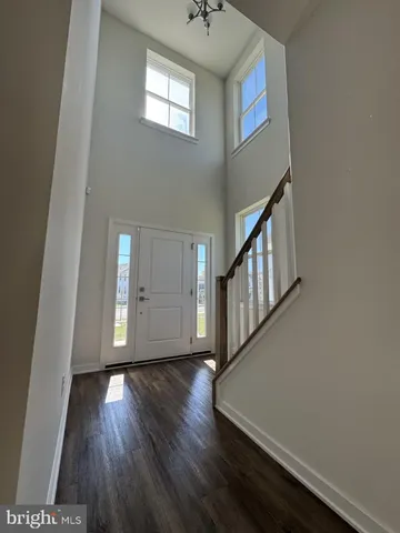a view of an entryway with wooden floor