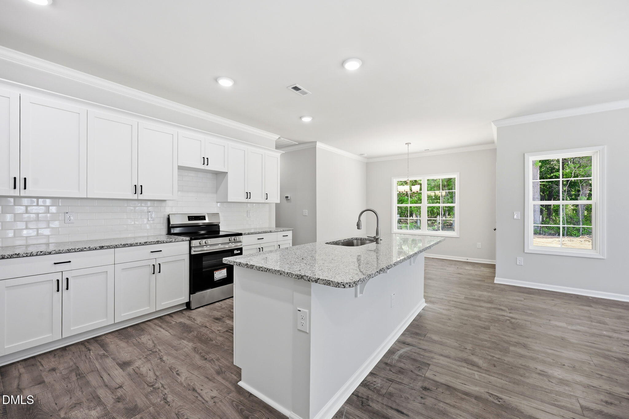 191 Nectar Lane Bunnlevel, NC 28323 - Photo 9 of 35 a large kitchen with granite countertop a sink and a stove top oven