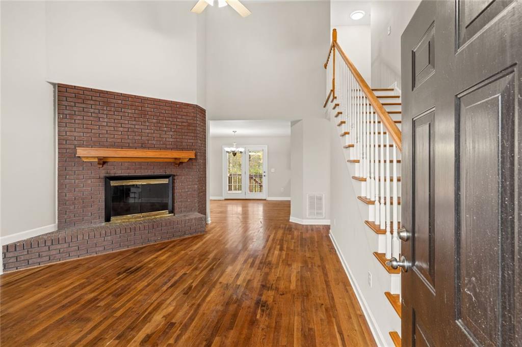 4239 Mangum Mill Road Gainesville, GA 30507 - Photo 12 of 33 a view of an empty room with wooden floor fireplace and a window