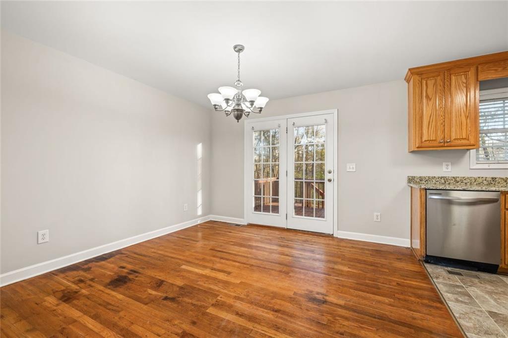 4239 Mangum Mill Road Gainesville, GA 30507 - Photo 15 of 33 a view of an empty room with window and wooden floor