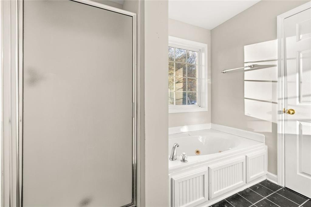 4239 Mangum Mill Road Gainesville, GA 30507 - Photo 17 of 33 a white bath tub sitting next to a window