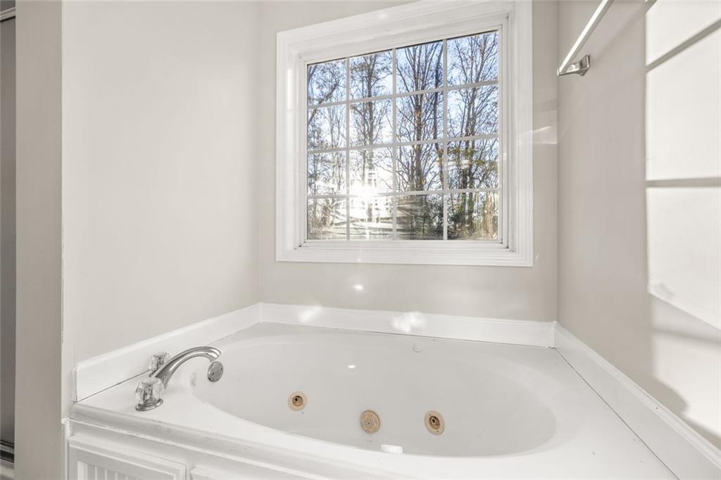 4239 Mangum Mill Road Gainesville, GA 30507 - Photo 18 of 33 a white bath tub sitting in a bathroom next to a window