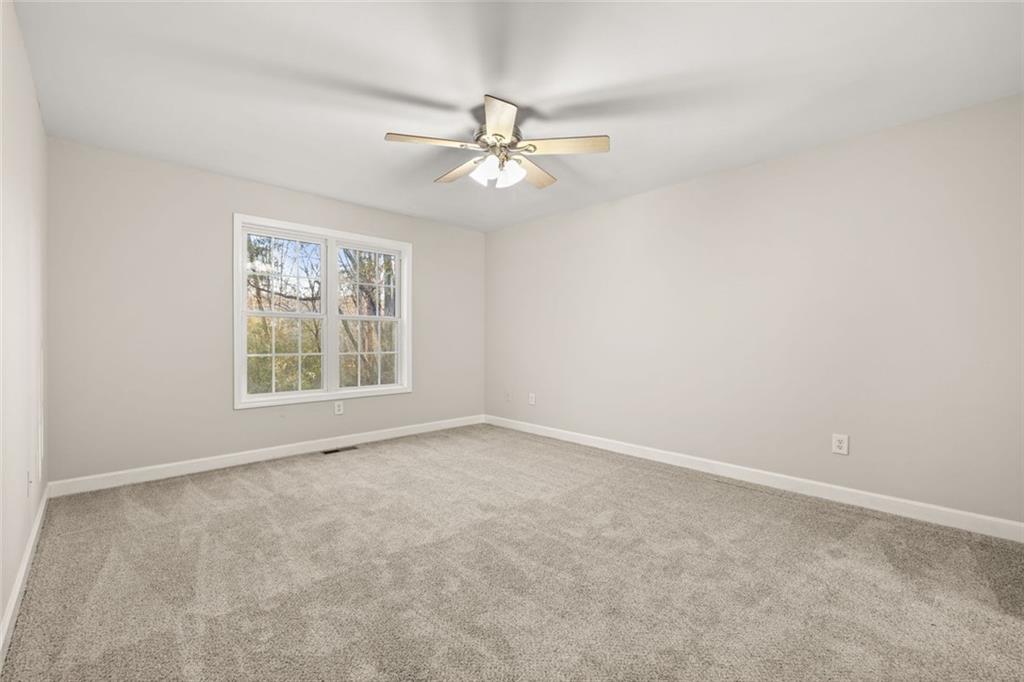 4239 Mangum Mill Road Gainesville, GA 30507 - Photo 19 of 33 an empty room with windows and fan