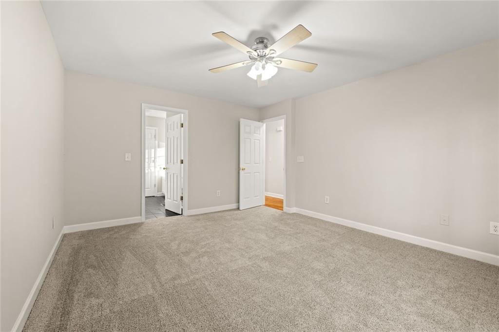 4239 Mangum Mill Road Gainesville, GA 30507 - Photo 20 of 33 an empty room with fan and windows