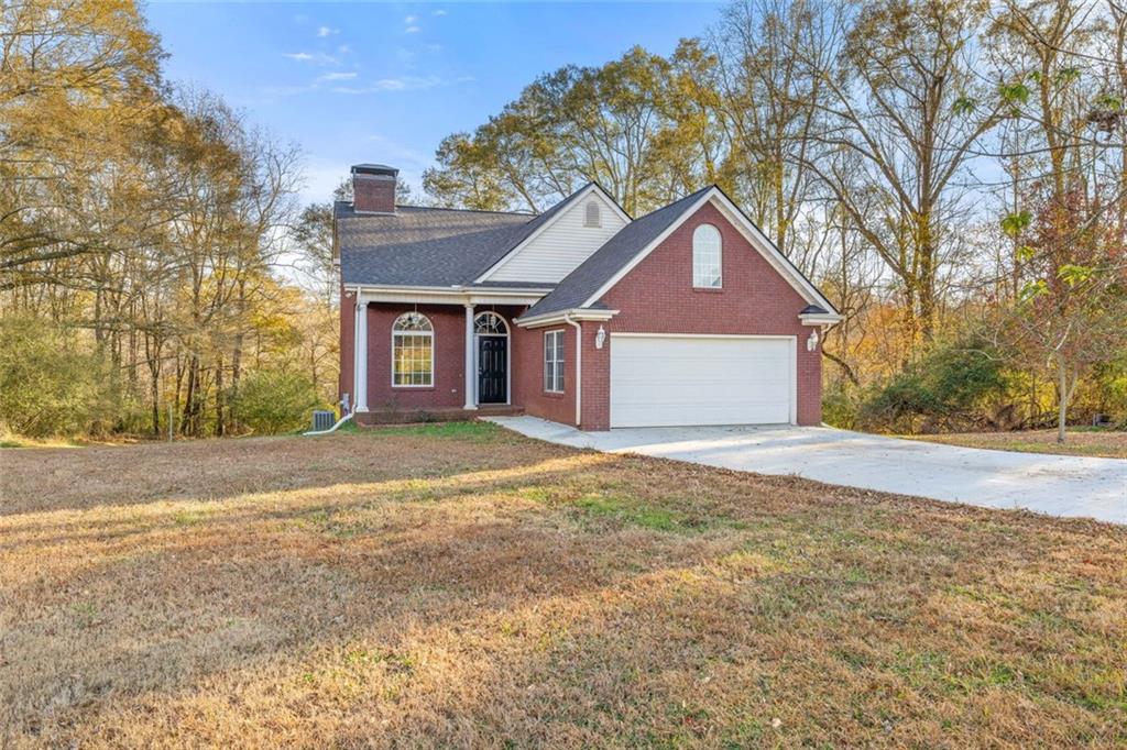 4239 Mangum Mill Road Gainesville, GA 30507 - Photo 2 of 33 a front view of a house with a yard and garage
