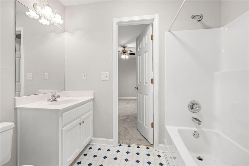 4239 Mangum Mill Road Gainesville, GA 30507 - Photo 23 of 33 a bathroom with a sink a toilet and shower