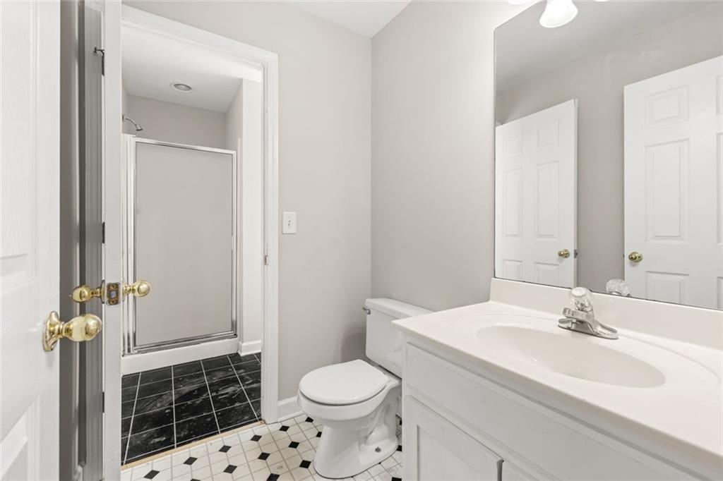 4239 Mangum Mill Road Gainesville, GA 30507 - Photo 25 of 33 a bathroom with a sink toilet and shower