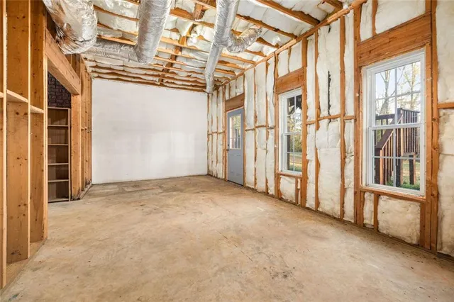 a view of a dry yard with wooden fence