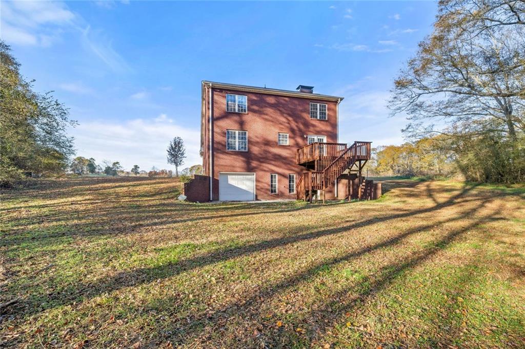 4239 Mangum Mill Road Gainesville, GA 30507 - Photo 9 of 33 a view of a house with a yard and sitting area
