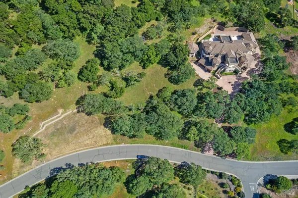 an aerial view of a house with a yard