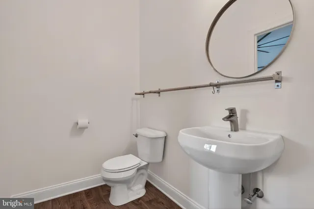 a room with round mirror and cabinets