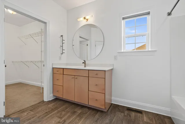 an empty room with chandelier fan