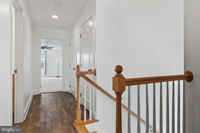 a view of a big room with wooden floor closet and windows