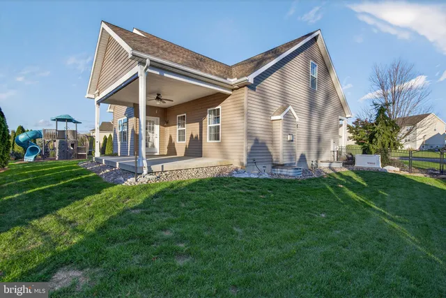 an aerial view of a house with garden space and street view