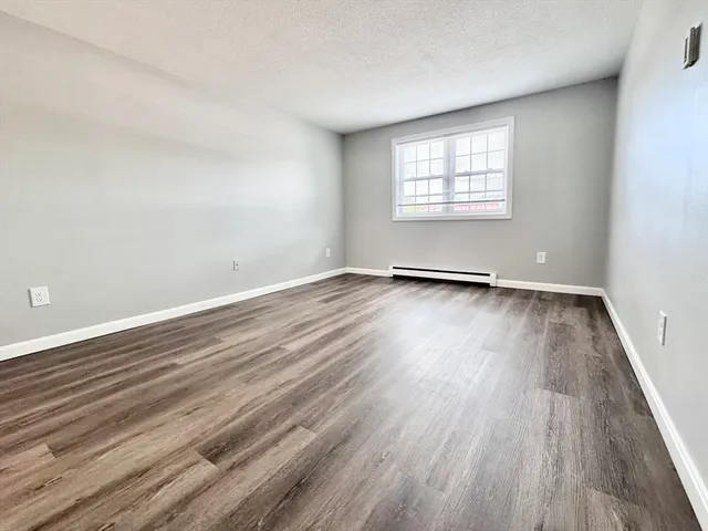 a view of an empty room and wooden floor