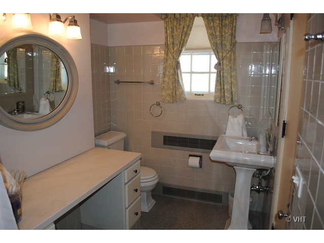200 River Bluff Road Elgin, IL 60120 - Photo 13 of 19 a bathroom with a sink mirror vanity and toilet