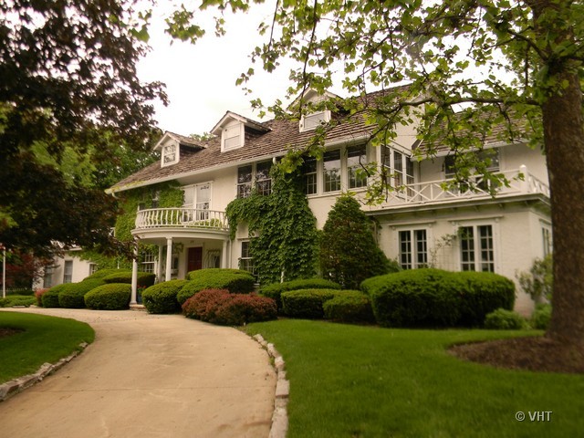 200 River Bluff Road Elgin, IL 60120 - Photo 3 of 19 a view of a white house next to a yard with plants and trees