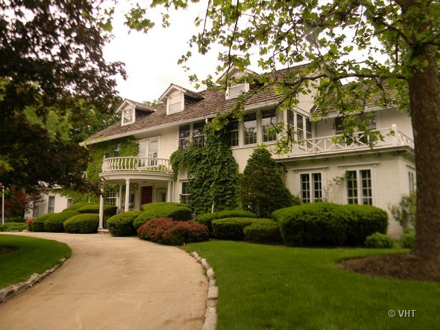 200 River Bluff Road Elgin, IL 60120 - Photo 4 of 19 a view of a white house next to a yard with plants and trees