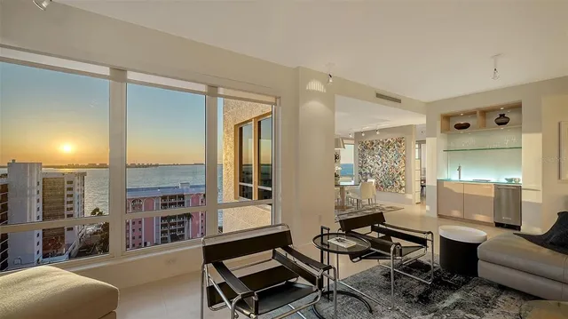 a view of a livingroom with furniture and floor to ceiling window
